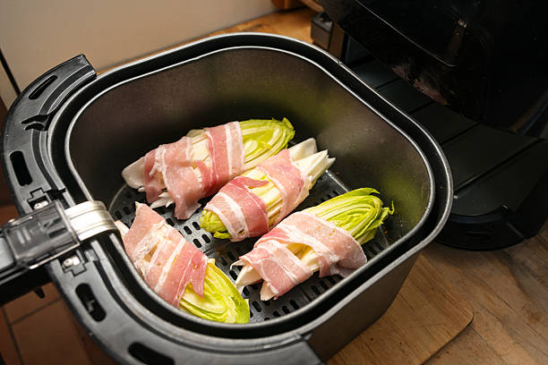 Cooking Bacon in Air Fryer with crispy bacon strips arranged in an air fryer basket, ready to serve.