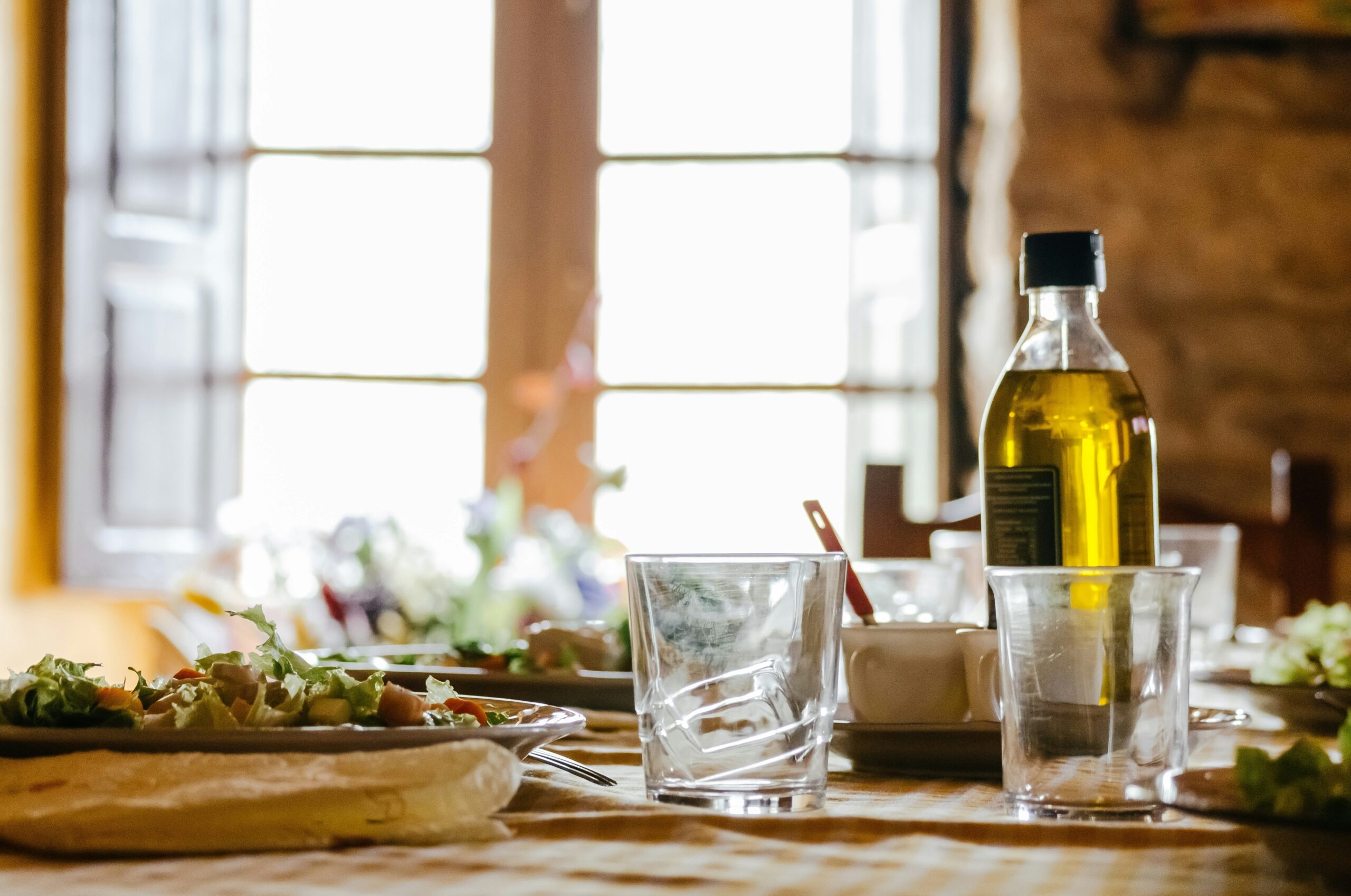 Understanding the Best Cooking Oils to Use featuring olive oil, avocado oil, and other popular cooking oils arranged with fresh ingredients.